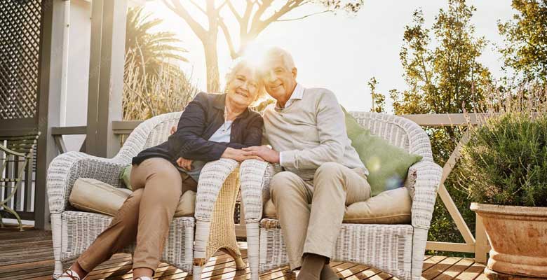 Senior homeowner sitting comfortably by a window